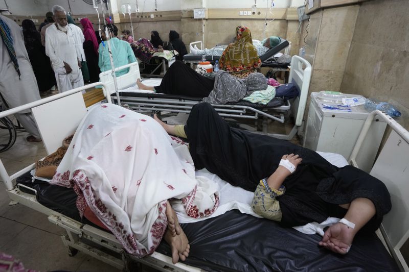 Patients of heatstroke receive treatment at a hospital in Karachi, Pakistan, Tuesday, June 25, 2024. Various parts of the country continued to experience an intense heat wave conditions, with the temperatures reaching 47 degree Celsius (116.6 Fahrenheit) in Nawabshah and other cities, according to the press release of Pakistan Meteorological Department. (AP Photo/Fareed Khan)