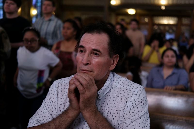 A parishioner prays during a Mass at St. Peter the Apostle Catholic Church in Reading, Pa., on Sunday, June 9, 2024. (AP Photo/Luis Andres Henao)