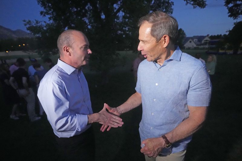 U.S. Sen. Mike Lee, left, shakes hands with U.S. Rep. John Curtis following his win during an election night party Tuesday, June 25, 2024, in Provo, Utah. Curtis has won the Utah GOP primary for Mitt Romney's open U.S. Senate seat, defeating one opponent who was endorsed by former President Donald Trump and others who said they supported Trump's agenda. (AP Photo/Rick Bowmer)