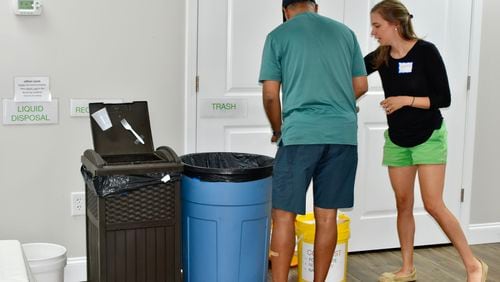 Kirkwood Presbyterian member Caroline McCormick (right) explains the church's composting guidelines. The church was named an Earth Care Congregation by the Presbyterian Church USA. Courtesy