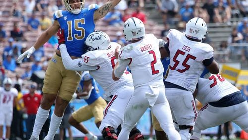 UCLA linebacker Laiatu Latu (15) pressures South Alabama quarterback Carter Bradley (2) during the third quarter at the Rose Bowl on Saturday, Sept. 17, 2022, in Pasadena, California. (Myung J. Chun/Los Angeles Times/TNS)