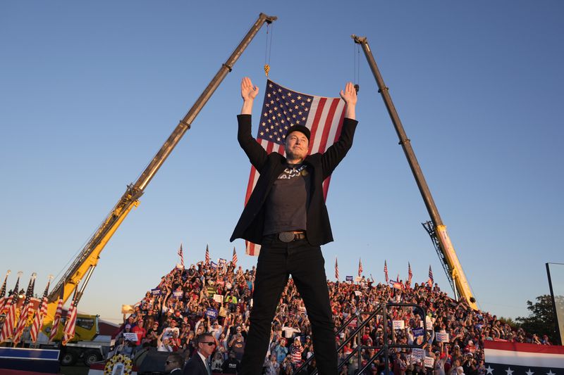 Tesla and SpaceX CEO Elon Musk walks to the stage to speak alongside Republican presidential nominee former President Donald Trump at a campaign event at the Butler Farm Show, Saturday, Oct. 5, 2024, in Butler, Pa. (AP Photo/Alex Brandon)