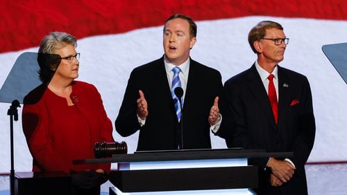 Brian Jack, center, a former aide to Donald Trump and now the Republican nominee in Georgia's 3rd Congressional District, speaks Monday at Fiserv Forum, where the Republican National Convention is being held in Milwaukee. He is flanked by Julianne Murray and Jeff Kent. (Arvin Temkar / AJC)