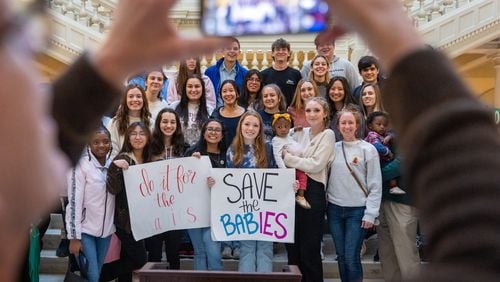 Anti-abortion activists pose for a photo at a Feb. 9. 2023, anti-abortion rally at the Georgia State Capitol in Atlanta.