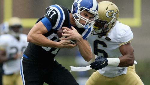 DURHAM, NC - SEPTEMBER 26: Chris Milton #6 of the Georgia Tech Yellow Jackets tries to tackle Max McCaffrey #87 of the Duke Blue Devils during their game at Wallace Wade Stadium on September 26, 2015 in Durham, North Carolina. (Photo by Streeter Lecka/Getty Images)