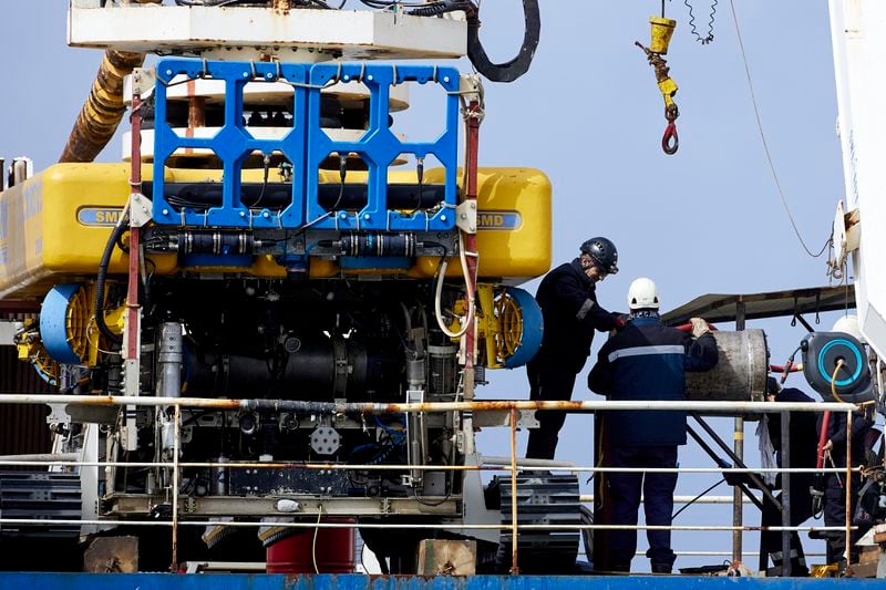 Workers on the vessel Nautilus that helped bury the subsea cables that run 10-12 miles along the ocean floor to connect the wave energy test site to facilities on land near Newport, Ore., Friday, Aug. 23, 2024. (AP Photo/Craig Mitchelldyer)