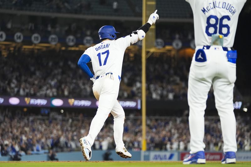 Los Angeles Dodgers designated hitter Shohei Ohtani (17) runs the bases after hitting a grand slam during the ninth inning of a baseball game against the Tampa Bay Rays in Los Angeles, Friday, Aug. 23, 2024. The Dodgers won 7-3. Will Smith, Tommy Edman, and Max Muncy also scored. (AP Photo/Ashley Landis)