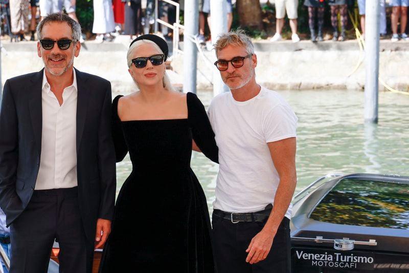 Director Todd Phillips, from left, Lady Gaga and Joaquin Phoenix pose for photographers upon arrival for the press conference of the film 'Joker: Folie A Deux' during the 81st edition of the Venice Film Festival in Venice, Italy, on Wednesday, Sept. 4, 2024. (Photo by Joel C Ryan/Invision/AP)