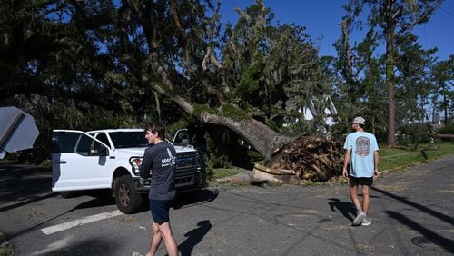 Austin Fosdick (left) and Nealy Hiers, both students at Valdosta State University, check out damages caused by Hurricane Helene near Valdosta State University, Saturday, September 28, 2024, in Valdosta. The devastation in Valdosta was extensive after the South Georgia city was battered with hurricane-force winds on Helene’s path across the state. Damaging Helene has swept through Georgia, leading to at least 15 deaths. All 159 counties are now assessing the devastation and working to rebuild, even as serious flooding risks linger. (Hyosub Shin / AJC)