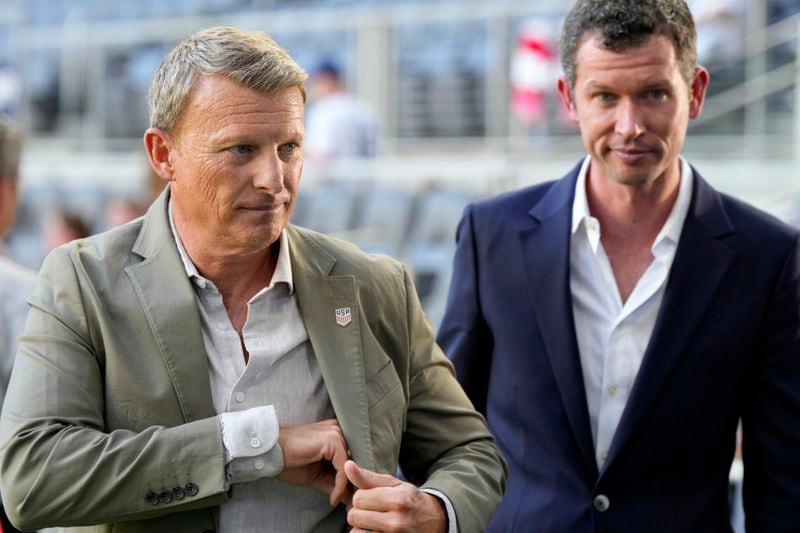 United States sporting director Matt Crocker, left, walks with CEO JT Batson prior to a friendly soccer match against New Zealand, Tuesday, Sept. 10, 2024, in Cincinnati. (AP Photo/Jeff Dean)