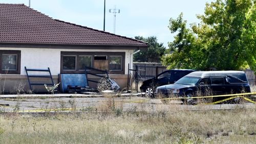 FILE - A hearse and debris sit behind the Return to Nature Funeral Home in Penrose, Colo., on Oct. 5, 2023. (Jerilee Bennett/The Gazette via AP, File)