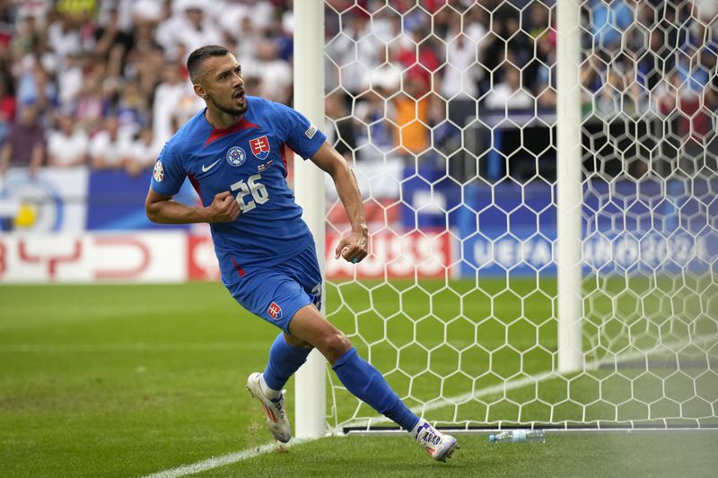 Slovakia's Ivan Schranz celebrates after scoring his side's opening goal during a round of sixteen match between England and Slovakia at the Euro 2024 soccer tournament in Gelsenkirchen, Germany, Sunday, June 30, 2024. (AP Photo/Ariel Schalit)