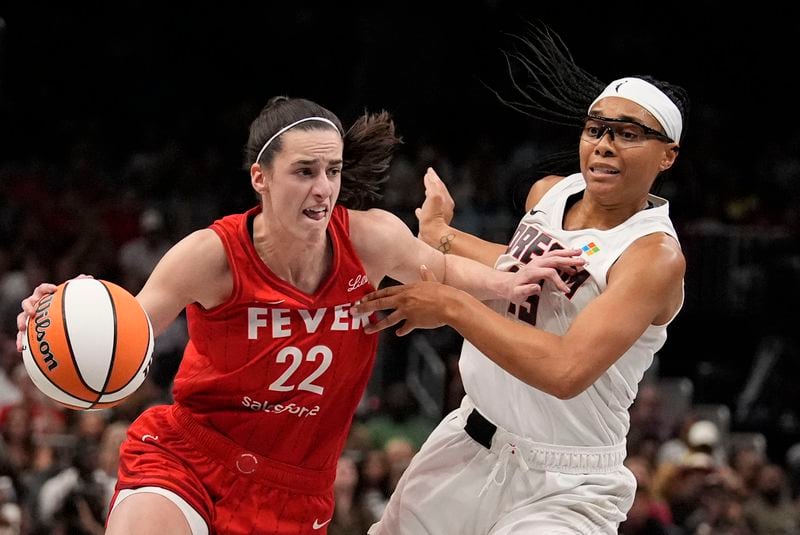 Indiana Fever's Caitlin Clark (22) dribbles the ball against Atlanta Dream's Allisha Gray (15) in the first half of an WNBA basketball game, Monday, Aug. 26, 2024, in Atlanta. (AP Photo/Brynn Anderson)