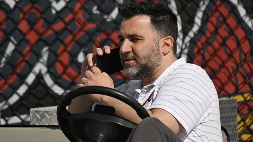 Atlanta Braves general manager Alex Anthopoulos talks on the phone during spring training workouts at CoolToday Park, Wednesday, Feb. 21, 2024, in North Port, Florida. (Hyosub Shin / Hyosub.Shin@ajc.com)