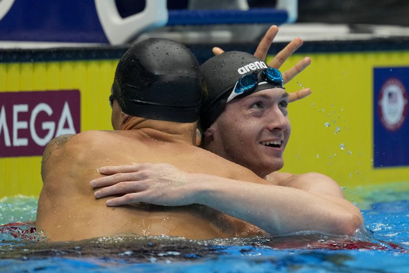 Caeleb Dressel and Chris Guiliano embrace after the Men's 50 freestyle finals Friday, June 21, 2024, at the US Swimming Olympic Trials in Indianapolis. (AP Photo/Michael Conroy)
