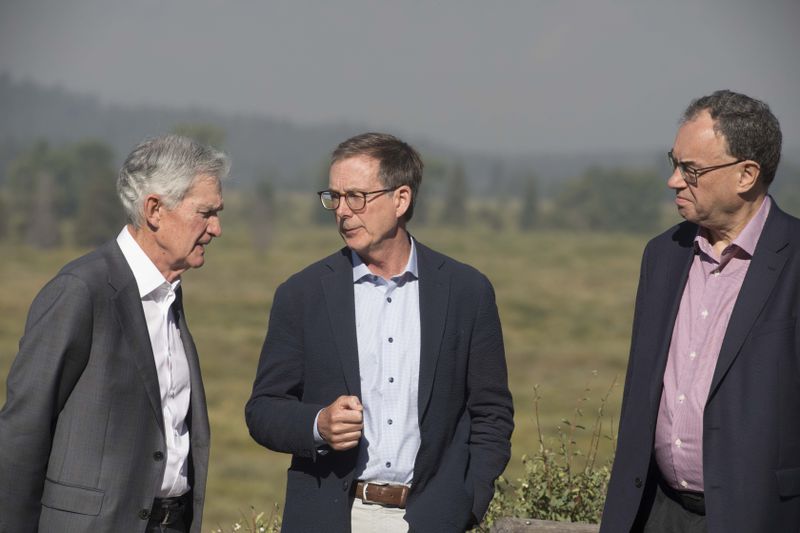 Federal Reserve Chairman Jerome Powell, left, Governor of the Bank of Canada Tiff Macklem, center, and Governor of the Bank of England Andrew Bailey pose for a photo at the Jackson Hole Economic Symposium at Jackson Lake Lodge in Grand Teton National Park near Moran, Wyo., on Aug. 23, 2024. (AP Photo/Amber Baesler)