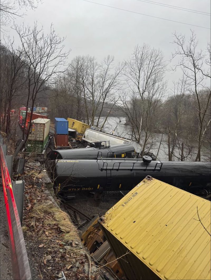 This photo provided by Nancy Run Fire Company shows a train derailment along a riverbank in Saucon Township, Pa., on Saturday, March 2, 2024.   Authorities said it was unclear how many cars were involved but no injuries or hazardous materials were reported.   (Nancy Run Fire Company via AP)
