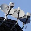 FILE - In this Feb. 23, 2011, file photo, Dish Network satellite dishes are shown at an apartment complex in Palo Alto, Calif. (AP Photo/Paul Sakuma, File)