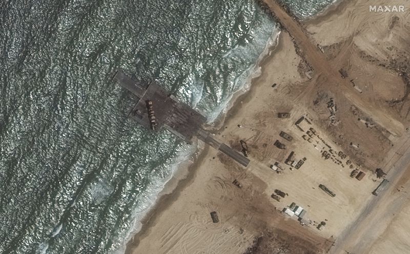 This Satellite image provided by Maxar Technologies shows a closer view of remaining section of the temporary pier on Wednesday, May 29, 2024 off Gaza. (Maxar Technologies via AP)