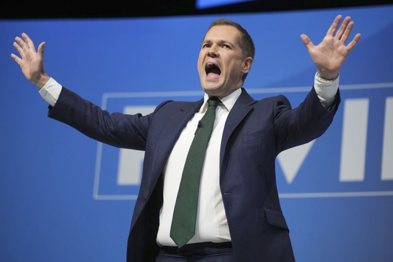 Conservative leadership candidate Robert Jenrick addresses members during the Conservative Party Conference at the International Convention Centre in Birmingham, England, Wednesday, Oct. 2, 2024.(AP Photo/Kin Cheung)