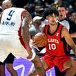 Atlanta Hawks forward Zaccharie Risacher (10) handles the ball against Washington Wizards forward Justin Champagnie (9) during the first half of an NBA summer league basketball game Friday, July 12, 2024, in Las Vegas. (AP Photo/David Becker)