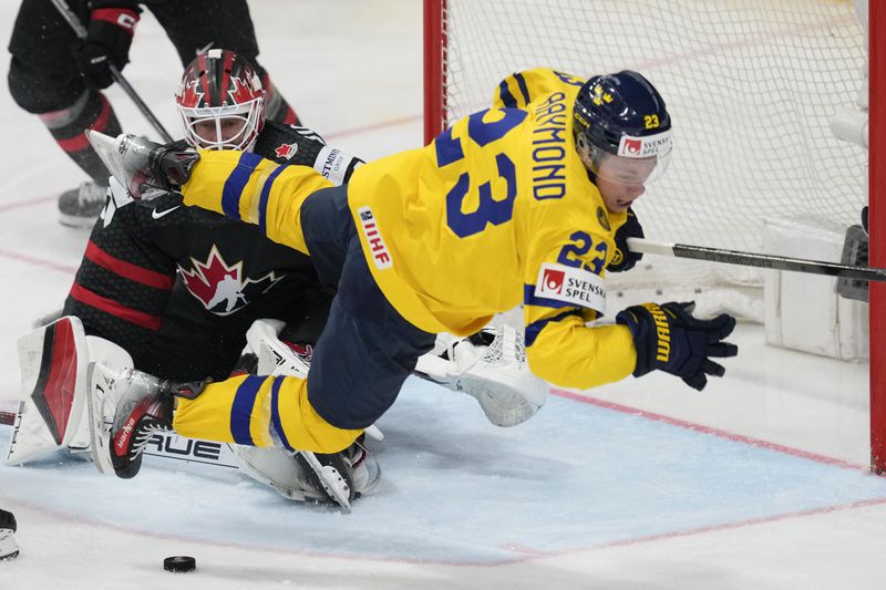 Canada's goalkeeper Jordan Binnington makes a save in front of Sweden's Lucas Raymond, front right, during the bronze medal match between Sweden and Canada at the Ice Hockey World Championships in Prague, Czech Republic, Sunday, May 26, 2024. (AP Photo/Darko Vojinovic)