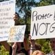 Students who walked out of their schools Friday hold up signs during a rally at J.B. Williams Park on Sept. 20, 2024. (Olivia Bowdoin for the AJC)