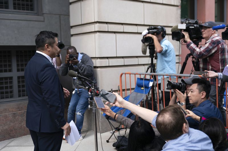 TikTok content creator Paul Tran talk to the press as he leaves the federal courthouse in Washington, Monday, Sept. 16, 2024, after a hearing on TikTok's lawsuit against the federal government. (AP Photo/Jose Luis Magana)