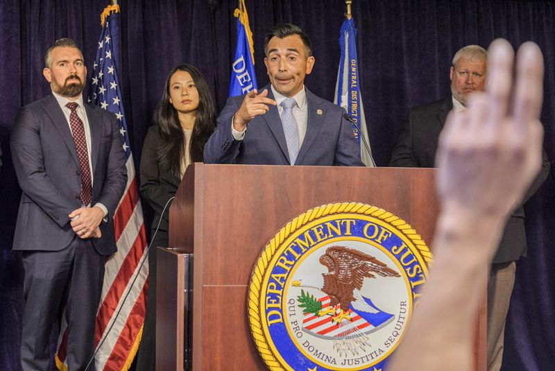 United States Attorney Martin Estrada, at podium, takes questions from the media after announcing court filings related to the death of actor Matthew Perry in Los Angeles on Thursday, Aug. 15, 2024. (AP Photo/Damian Dovarganes)