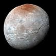 This image provided by NASA shows an enhanced color view of Pluto’s big moon Charon captured by the New Horizons spacecraft, July 14, 2015. (NASA via AP)