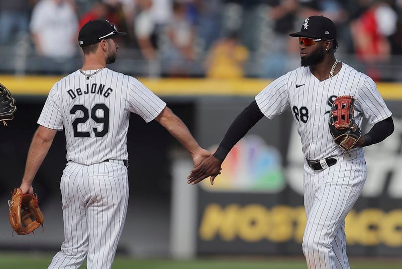 Chicago White Sox's Luis Robert Jr., right, celebrates with Paul DeJong after the team's 1-0 win over the Atlanta Braves in a baseball game Thursday, June 27, 2024, in Chicago. (AP Photo/Melissa Tamez)