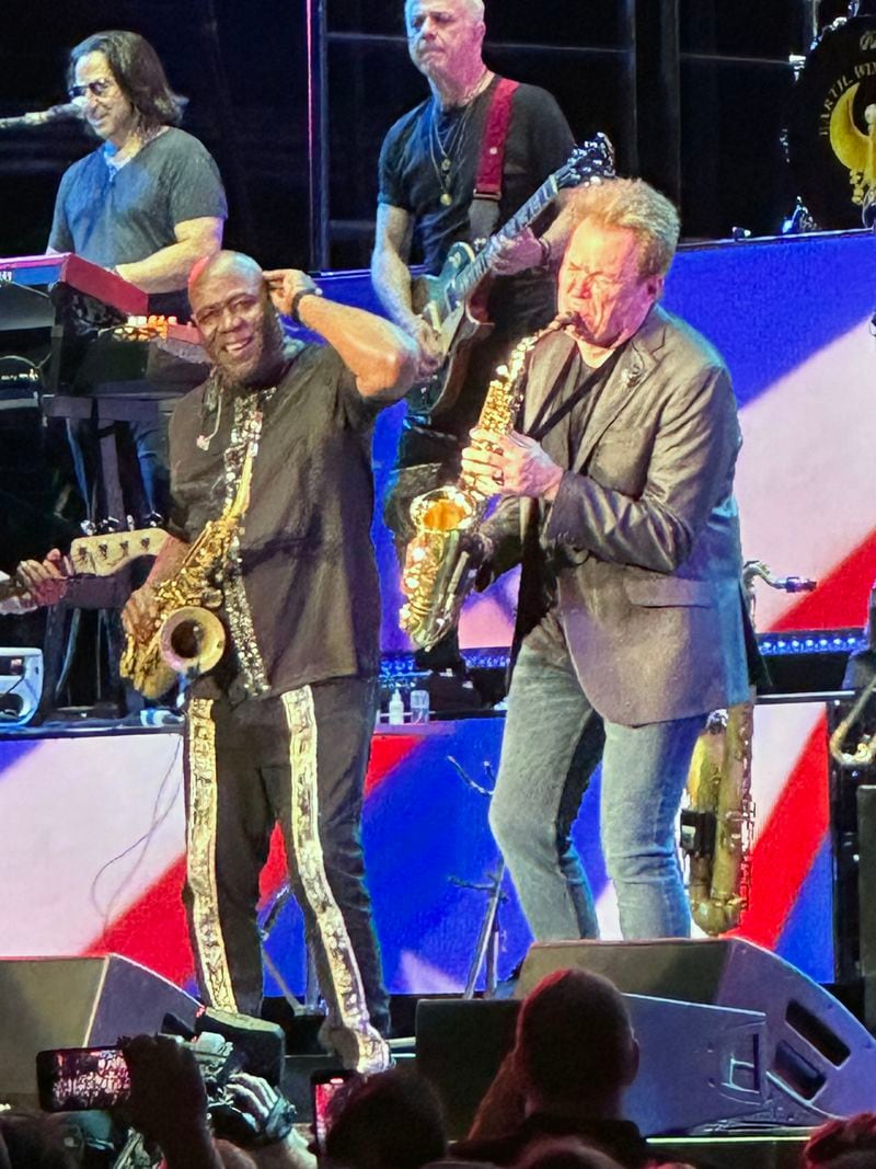 Gary Bias of Earth, Wind & Fire and Ray Herrmann of Chicago combine forces during the merged set of the two bands at Ameris Bank Amphitheatre in Alpharetta. RODNEY HO/rho@ajc.com