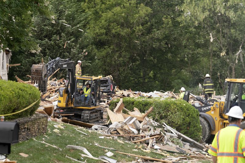 Crew workers remove debris after a house exploded in Bel Air, Md. neighborhood on Sunday, Aug. 11, 2024. (AP Photo/Jose Luis Magana)