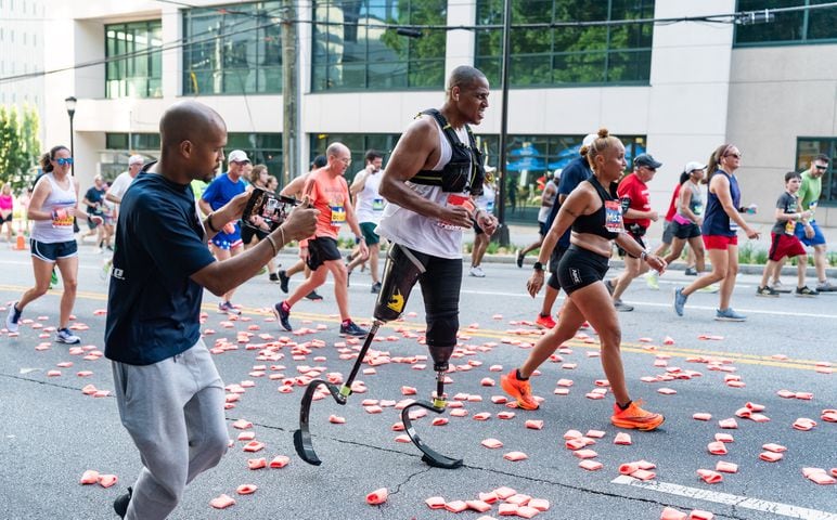 A runner with prosthetic legs participates in the 55th running of The Atlanta Journal-Constitution Peachtree Road Race at "Cardiac Hill" on Peachtree Road NW in Atlanta on Thursday, July 4, 2024. (Seeger Gray / AJC)