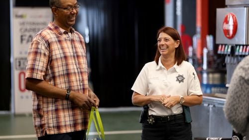 Investigator Kristine Sahms, right, with the Cobb County Sheriff’s Office, talks with Marines and Army veteran Ron Ellerbee, of Conyers, during a Veterans Job Fair at Mercedes-Benz Stadium, Thursday, September 29, 2022, in Atlanta. Around 300 veterans met with over 60 organizations at this job fair hosted by DAV and Recruit Military. (Jason Getz / Jason.Getz@ajc.com)