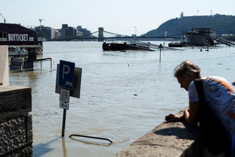 People watch the Danube river as it floods it's banks in central Budapest, Hungary, Thursday, Sept. 19, 2024. (AP Photo/Denes Erdos)