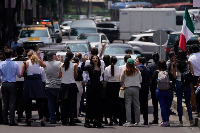 Law students block a street to protest against constitutional reform proposals that would make judges stand for election, outside a sports center where lawmakers are meeting as an alternative due to other demonstrators blocking Congress in Mexico City, Tuesday, Sept. 3, 2024. (AP Photo/Felix Marquez)