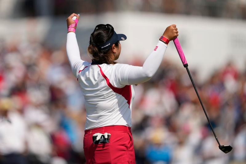 United States' Lilia Vu celebrates after making a putt on the 18th green to give the United States the win over Europe during the Solheim Cup golf tournament at the Robert Trent Jones Golf Club, Sunday, Sept. 15, 2024, in Gainesville, Va. (AP Photo/Matt York)