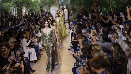 Models wear creations as part of the Elie Saab Spring/Summer 2025 collection presented Saturday, Sept. 28, 2024, in Paris. (Photo by Vianney Le Caer/Invision/AP)