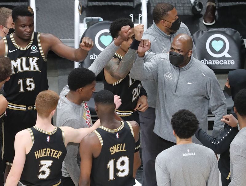 Atlanta Hawks interim head coach Nate McMillan gives his players a fist-bump as they take the court against Oklahoma City en route for their seventh consecutive victory Thursday, March 18, 2021, in Atlanta. (Curtis Compton / Curtis.Compton@ajc.com)