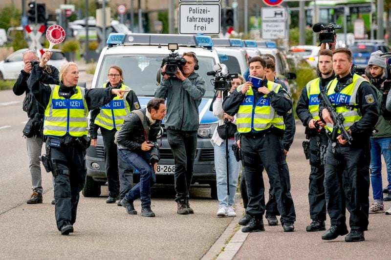 A German police officer stops a bus at the border between Germany and France, in Kehl, Germany, Monday, Sept. 16, 2024, as Germany begins carrying out checks at all its land borders. (AP Photo/Michael Probst)