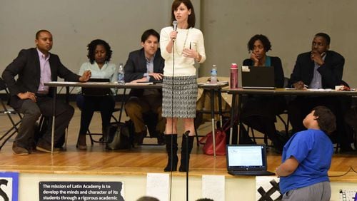 Kathleen Mathers (center), Latin Academy board member, speaks during a meeting earlier this year. HYOSUB SHIN / HSHIN@AJC.COM