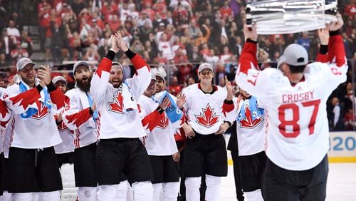 FILE - Canada's Sidney Crosby (87) hoists the trophy in front of teammates following Canada's 2-1 victory over Europe in Game 2 of the final to win the World Cup of Hockey, in Toronto, Sept. 29, 2016. (Frank Gunn/The Canadian Press via AP, File)