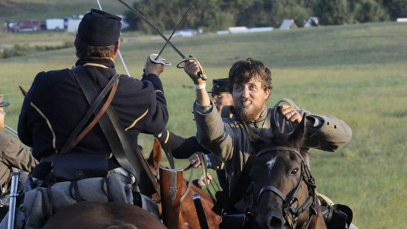 Union and Confederate cavalry members clash during a re-enactment at Nash Farm Battlefield in 2014. KENT D. JOHNSON / KDJOHNSON@AJC.COM
