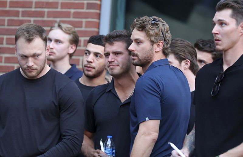 Columbus Blue Jackets player Cole Sillinger, center, reacts during the candlelight vigil to honor Columbus Blue Jackets hockey player Johnny Gaudreau, Thursday, Sept. 4, 2024, outside of Nationwide Arena in Columbus, Ohio. Gaudreau and his brother Matthew were killed by a motor vehicle last week while riding bicycles. (AP Photo/Joe Maiorana)