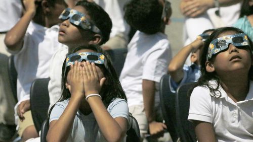 Woodward Elementary School in Atlanta held an eclipse viewing party in 2017, as the entire school dressed in white and watched the event with solar eclipse glasses. Some metro Atlanta schools are hosting events for the eclipse on April 8, 2024. (Bob Andres  / AJC file photo)