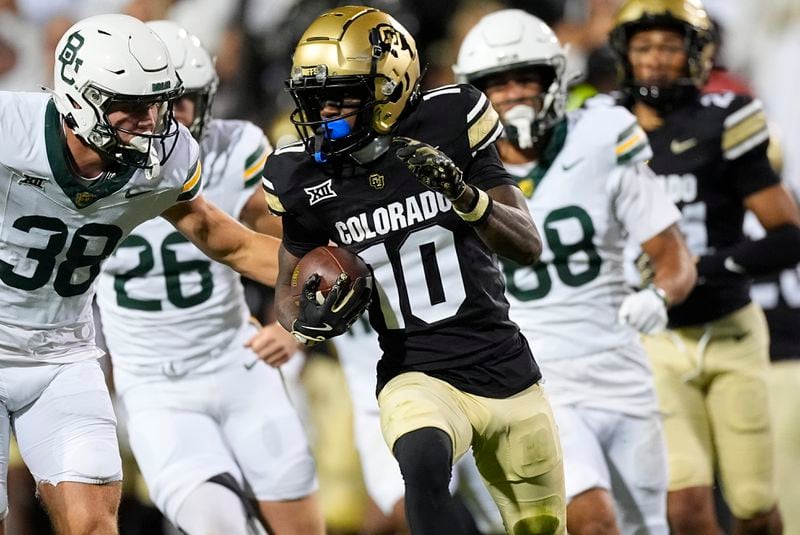 Baylor special teams player Jacob Redding, left, pursues Colorado punt returner LaJohntay Wester as he runs back a kick in the second half of an NCAA college football game Saturday, Sept. 21, 2024, in Boulder, Colo. (AP Photo/David Zalubowski)