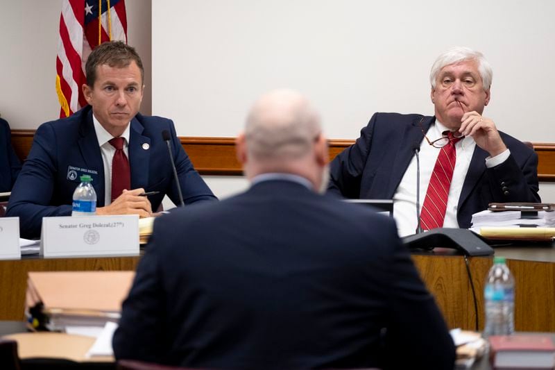 Send. Greg Dolezal (R-Cumming), left, and Bill Cowsert (R-Athens), chairman of the Senate Select Committee on Investigations, listen to testimony by Deputy Legislative Council Stuart Morelli on Friday, Sept. 13, 2024, at the State Capitol.   Ben Gray for the Atlanta Journal-Constitution