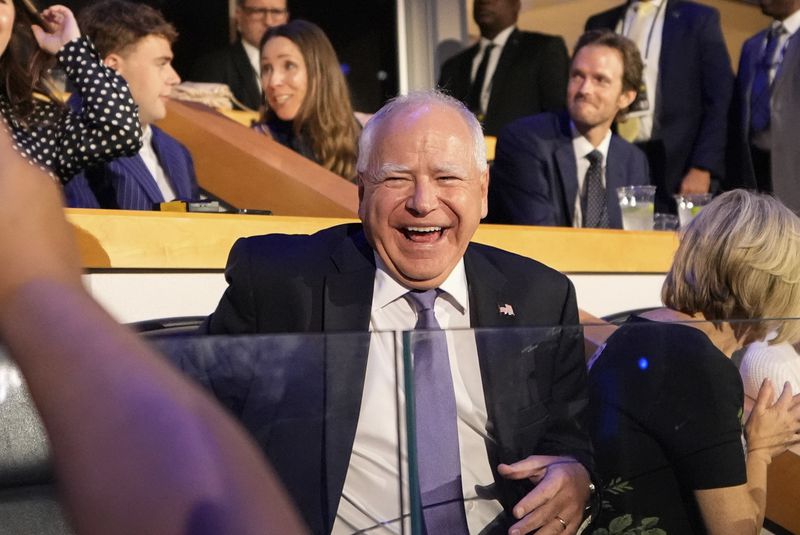 Democratic vice presidential nominee Minnesota Gov. Tim Walz laughs as he arrives at the Democratic National Convention Monday, Aug. 19, 2024, in Chicago. (AP Photo/Brynn Anderson)