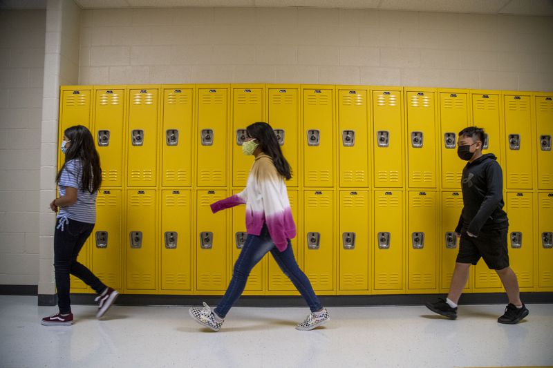 Students wearing face masks get a tour of their new school during the first day of school at Pearson Middle School in Marietta on Aug. 2. (Alyssa Pointer / Alyssa.Pointer@ajc.com)